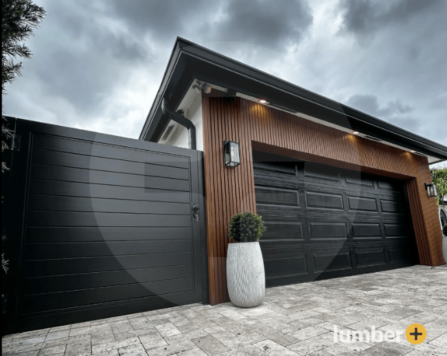 An image of a house with black composite fencing and matching composite cladding. 