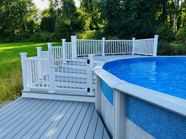 A corner platform with gated stairs is a smart above ground pool deck idea.