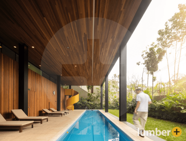 Hardwood siding extends from the exterior to the patio ceiling, considering hardwood siding costs.