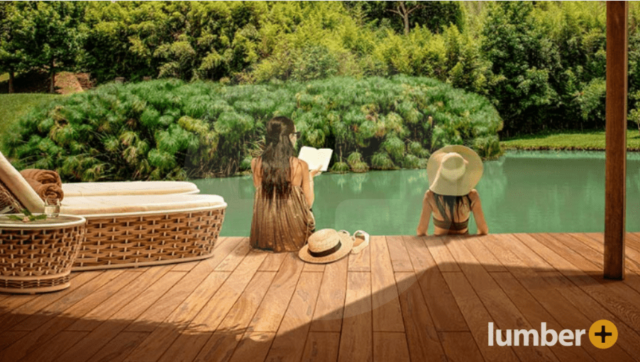 Two women relax on durable tropical decking made of Angelim wood.