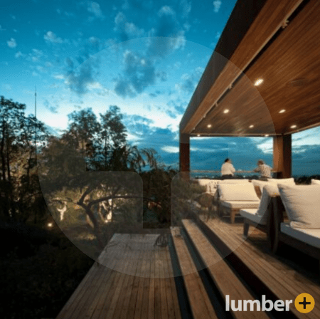 Wooden deck along a beach with recessed lighting. 