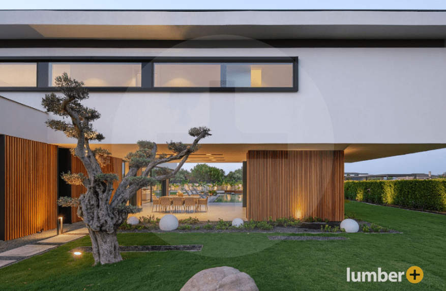 Contemporary vertical wood siding with integrated landscape lighting.