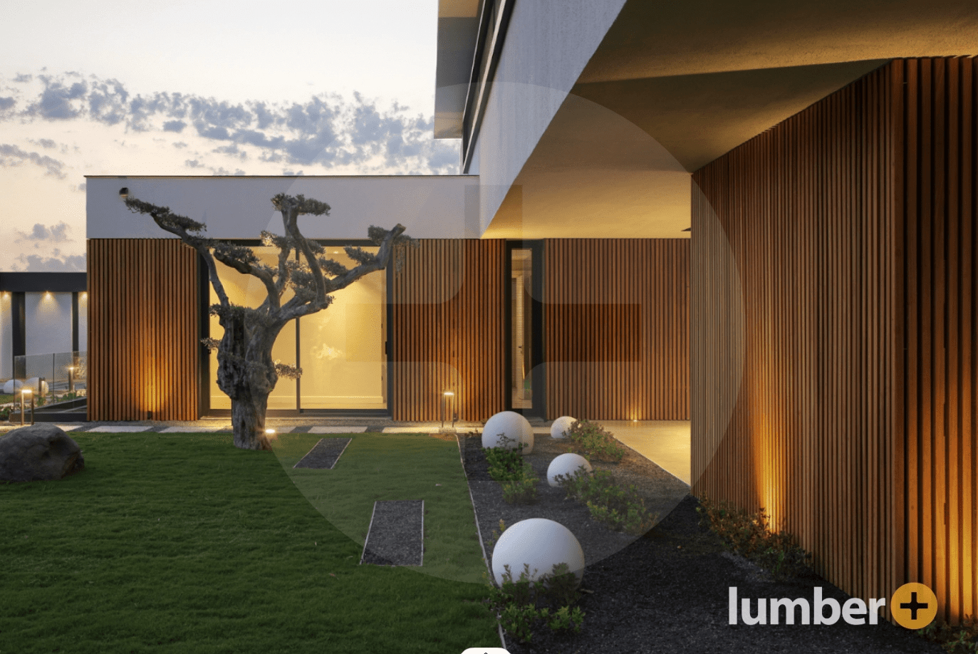 Modern home exterior with vertical wood siding and lighting.