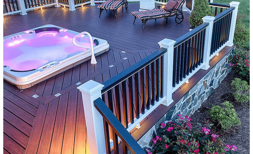 An image of a hot tub on wood deck at night—perfect for above ground pool deck ideas.