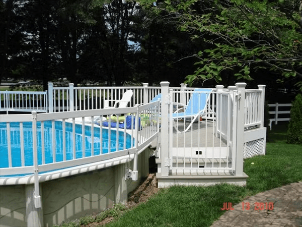 White rail gated deck with classic skirt—a timeless above ground pool deck idea