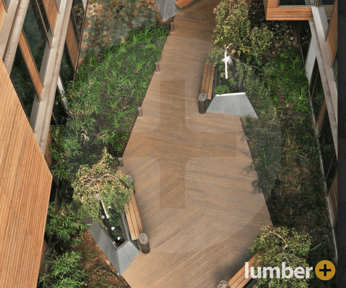 a Thermo Ash walkway with benches and greenery on each side