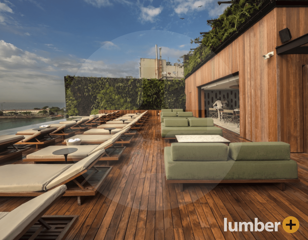 a poolside hardwood deck surrounded by natural elements