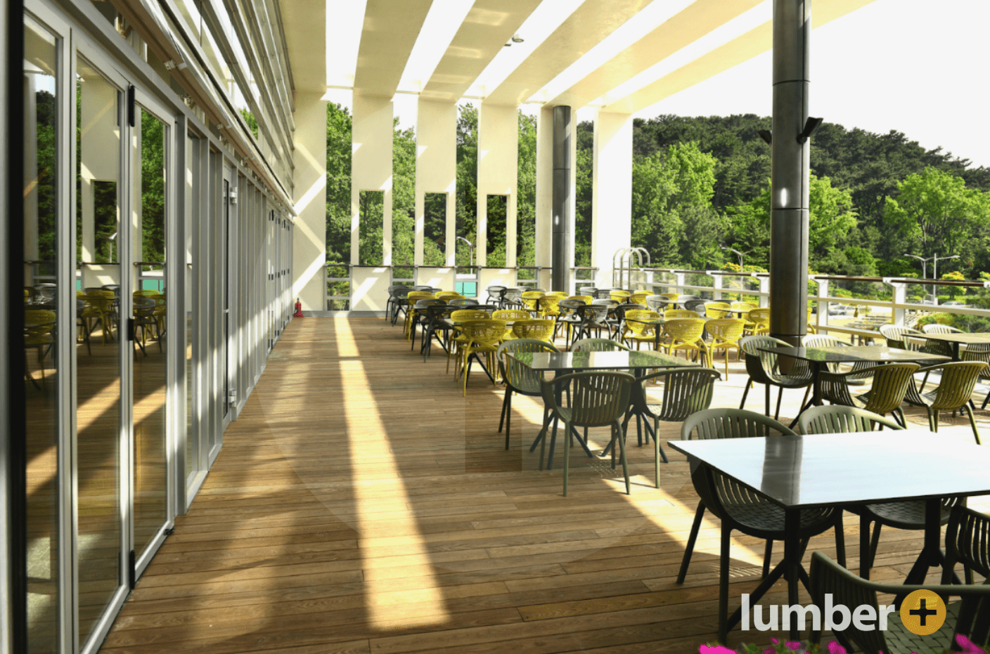 a modern wood patio with tables and chairs