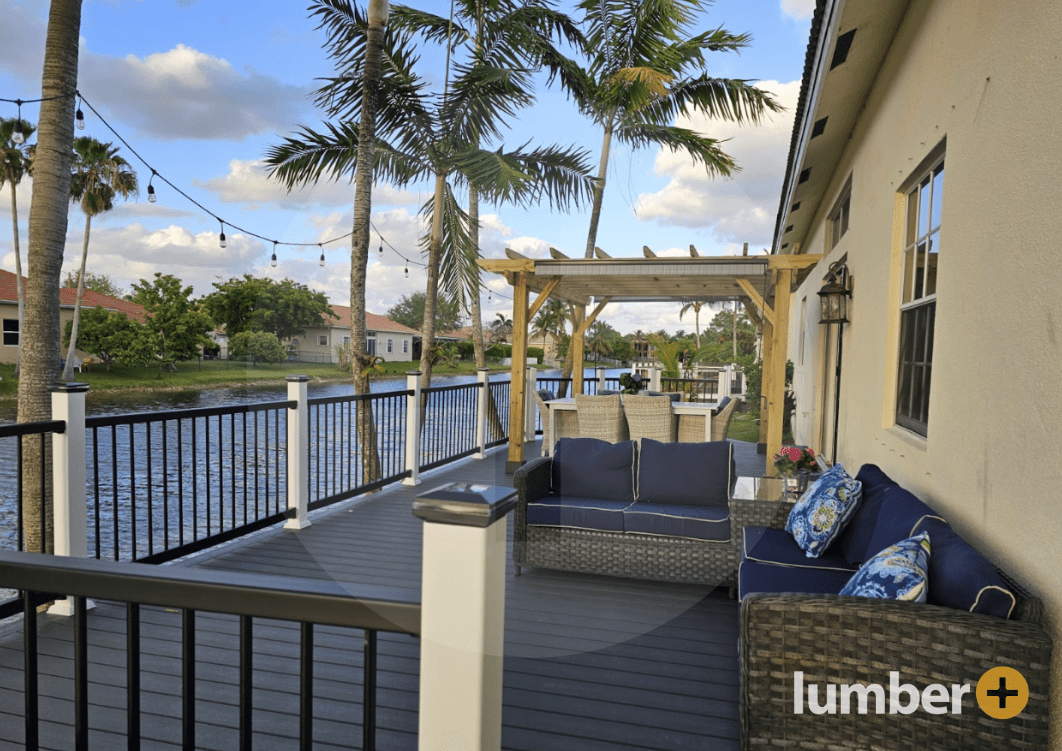 an image of a black PVC deck nearby lake water and palm trees