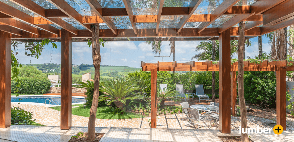 Wooden pergola next to a walkway leading to a pool.