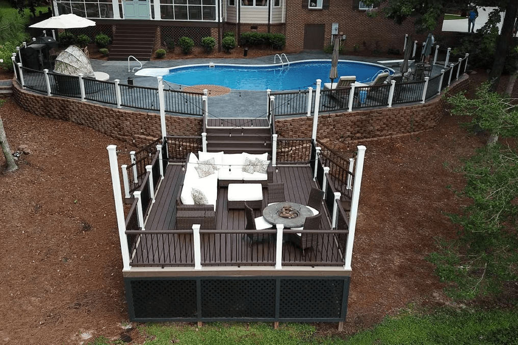 Trex pool deck in Lava Rock with Vintage Lantern railing, providing a rich red-brown tone and a striking appearance.