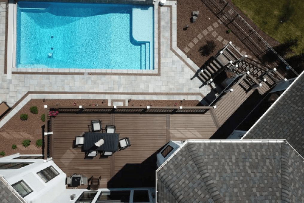 Trex pool deck in Spiced Rum with a cocktail rail, designed for poolside entertaining and relaxation.