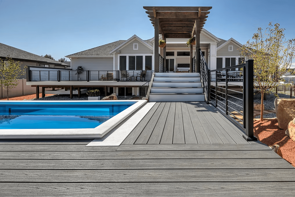 Trex pool deck in Island Mist, offering coastal vibes with a light gray, driftwood-like tone.