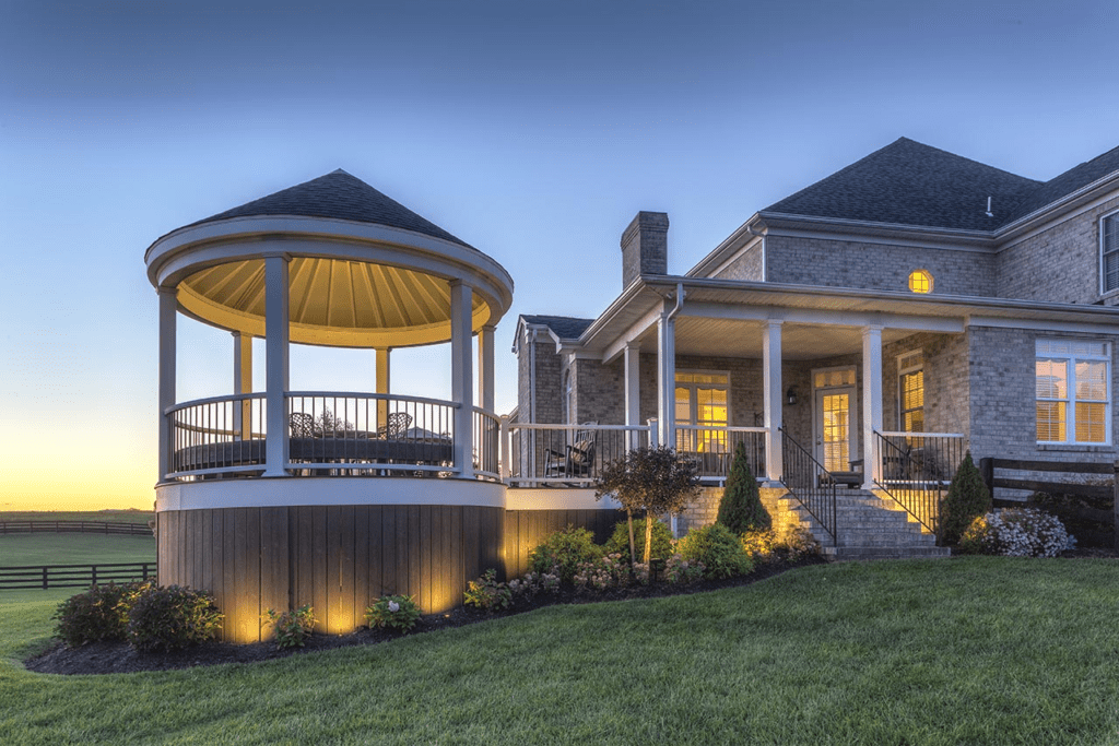 Trex deck with a connected round gazebo attached to the main deck, creating a cozy, rustic retreat.