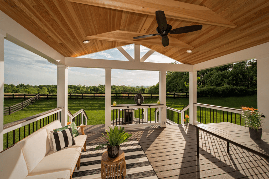 Trex deck with a wooden pergola and string lights, creating a rustic and inviting atmosphere.