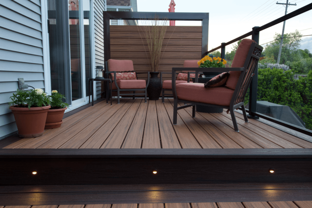 Trex deck with two-tone design and privacy wall, creating an intimate and stylish space.