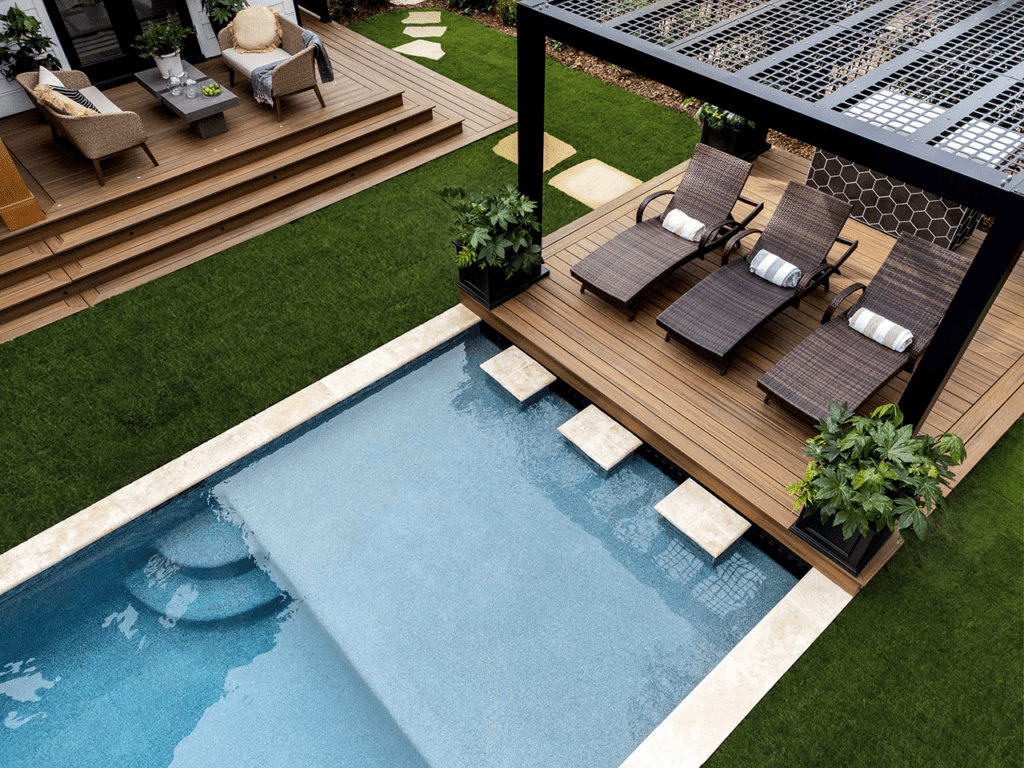 Trex poolside deck with pergola, offering a cohesive and spacious layout.