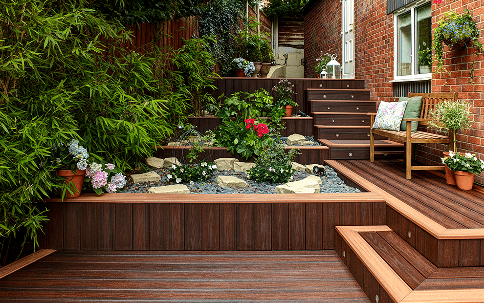 A multi-level Trex composite deck with rocks and plants.