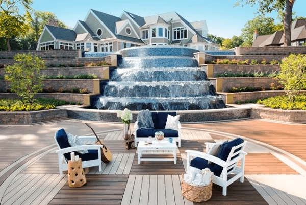 Multi-level Trex deck in brown and white basketweave with a waterfall and seating, highlighting Trex color combinations.