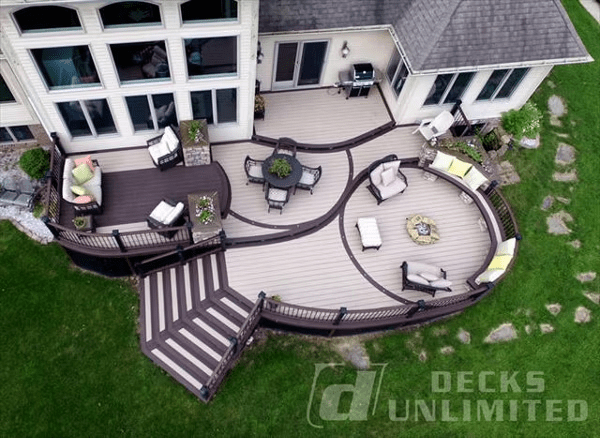 White and dark brown Trex deck with curves, lighting, firepit, built-in seating, planters, and storage.