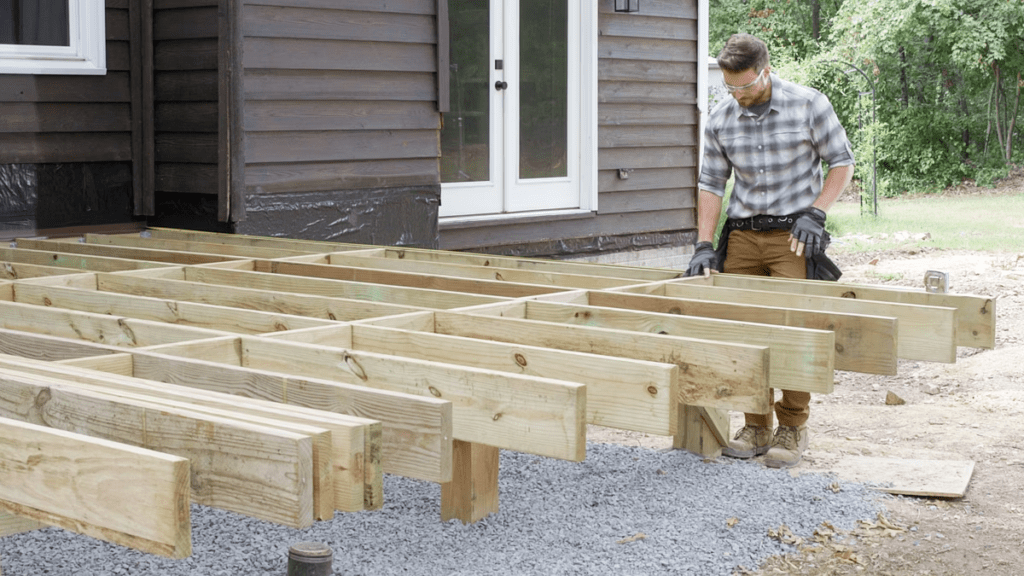 An image of a contractor installing deck framing for Trex.