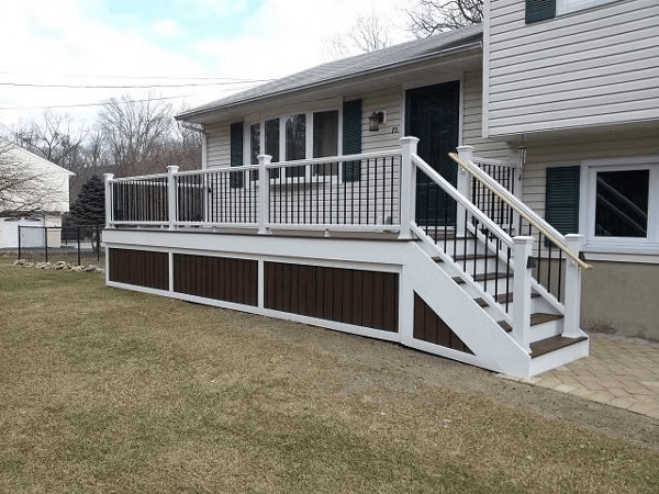 Rustic Trex deck skirting with horizontal boards in warm, natural tones, creating a cozy, grounded look.