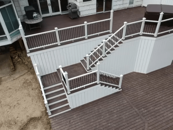 Multi-level dark brown Trex deck with vertical white skirting, providing a clean, enclosed look and modern contrast.