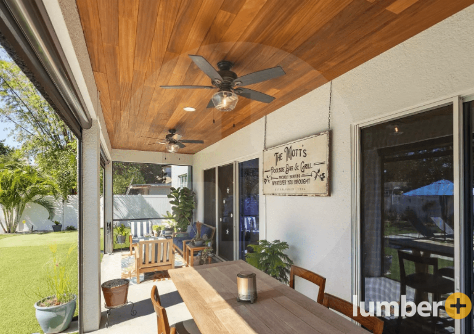 Hardwood ceiling installation on the back patio of a house.