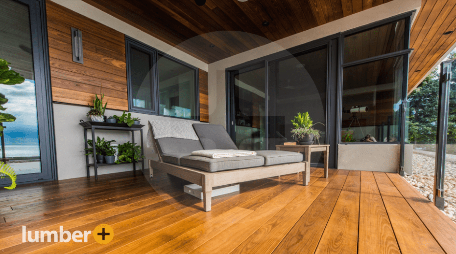 The outdoor patio of a house with wood siding.