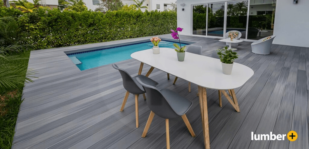 Deck on the outside of a house with a small, white table.