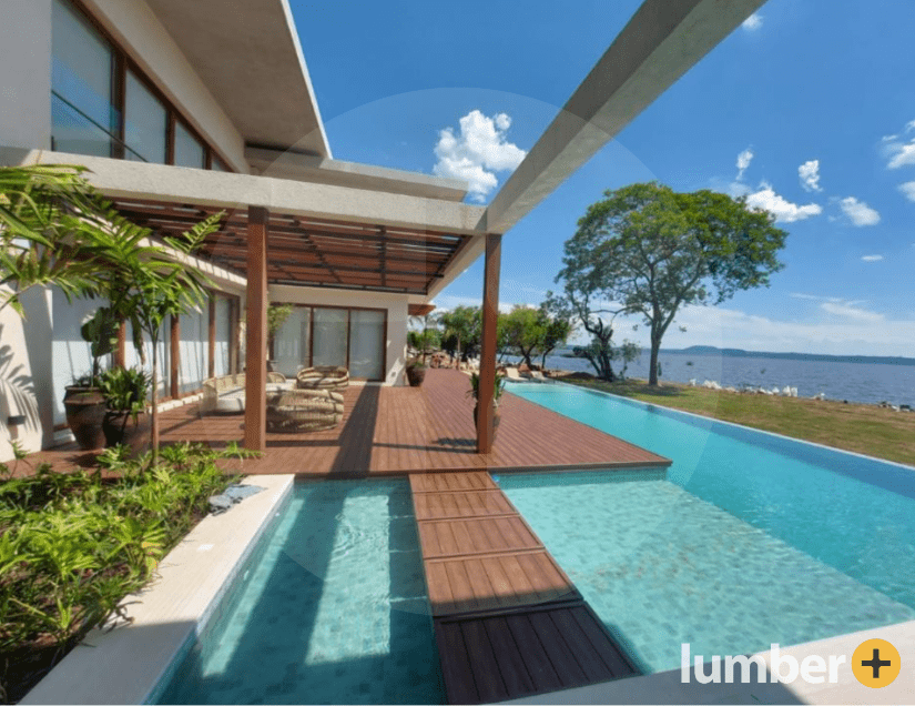 Brown composite decking lining the pool of a Miami home