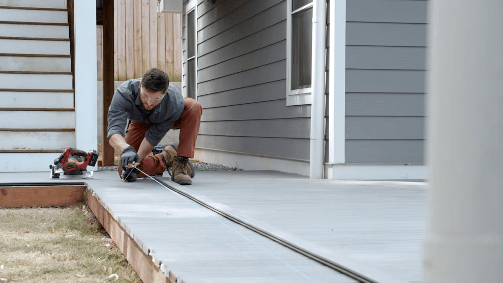 An image of a contractor measuring a current deck to replace it with Trex.