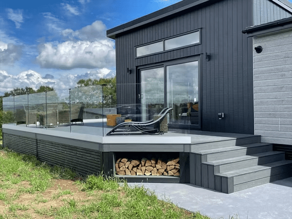 Gray Trex deck with a firewood storage cutout on the side, providing functional and stylish skirting.