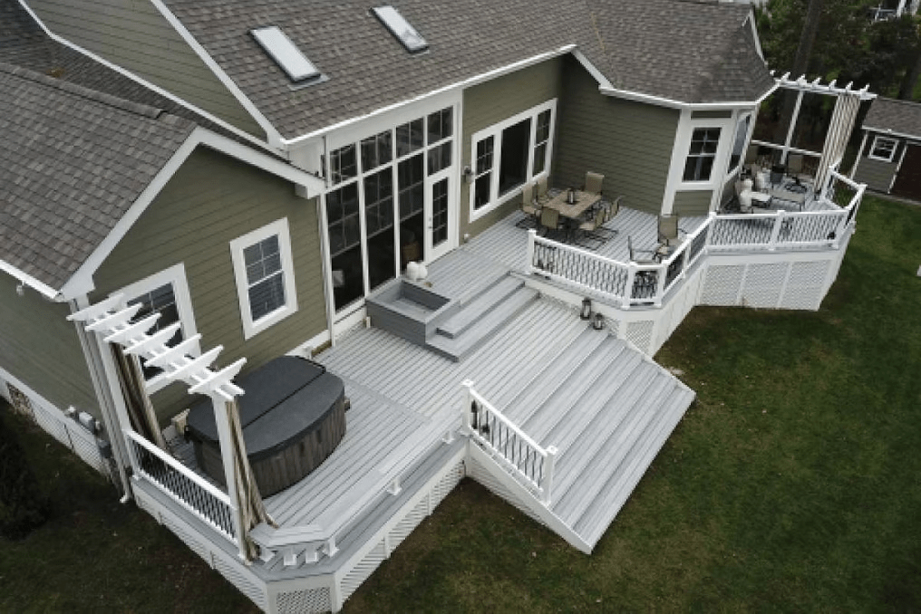 Wide Trex deck stairs featuring a classic white trim railing system.