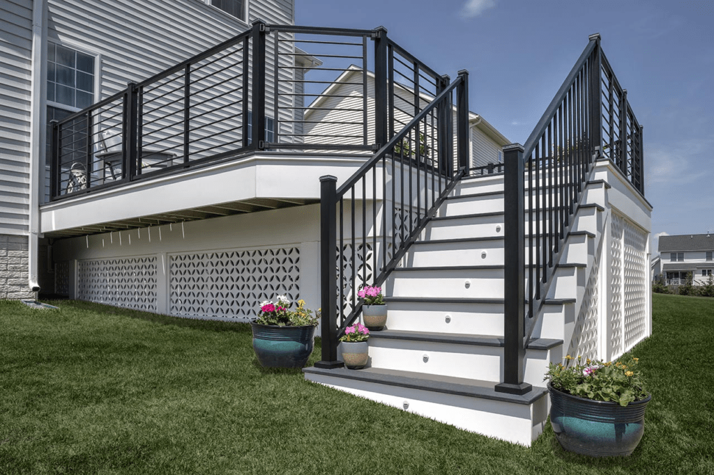 Trex deck stairs in gray and white paired with black railings for a sleek, modern design.