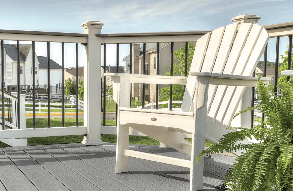 Image of Trex Select® decking in pebble grey with a white railing.