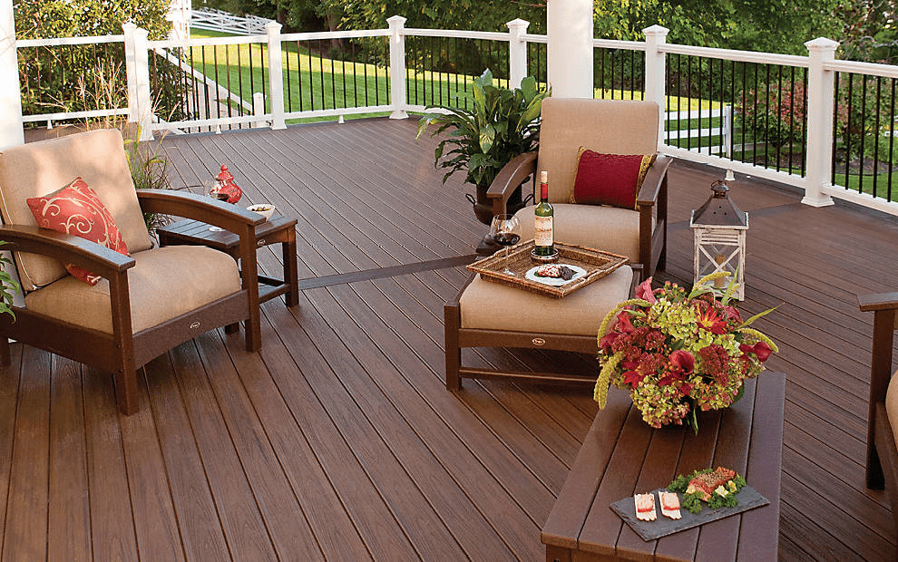 A dark Trex composite deck with railings and patio furniture.