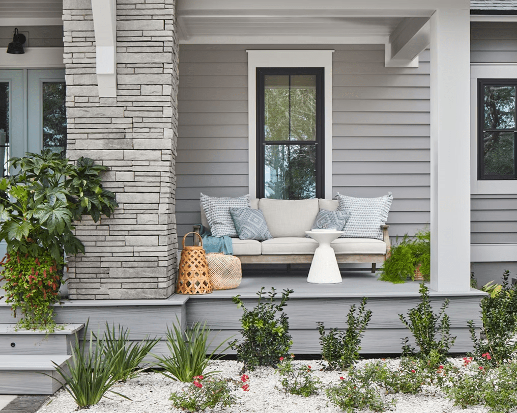 Raised patio with Rainier decking and matching fascia, complete with a cozy sitting area for lounging.