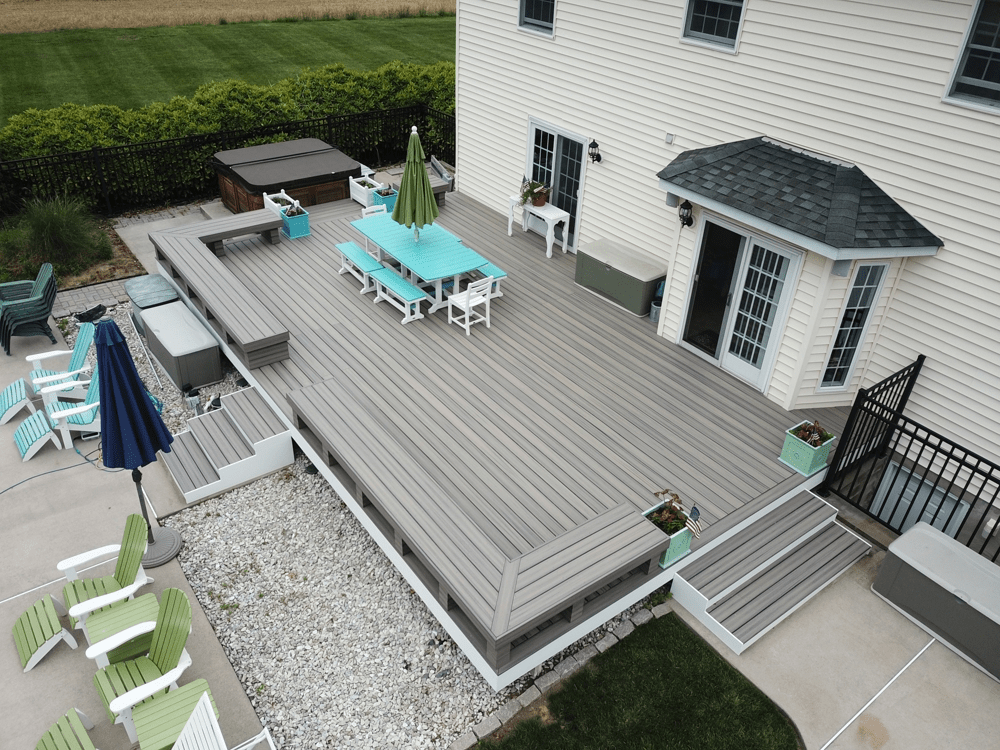 Light gray patio deck with white trim and perimeter benches for a clean and modern design.