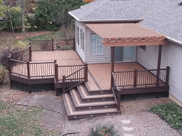 Trex deck in light brown with wrap-around steps and dark brown trim for added style and accessibility.