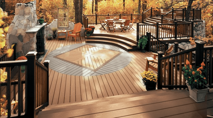 Multi-level Trex deck with rustic brown and gray tones, geometric inlay, and a fireplace for autumn gatherings.