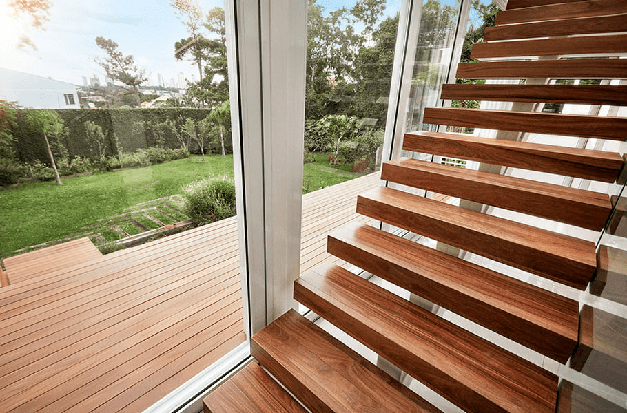 A Lumber Plus Cumaru wood deck elevated above a backyard