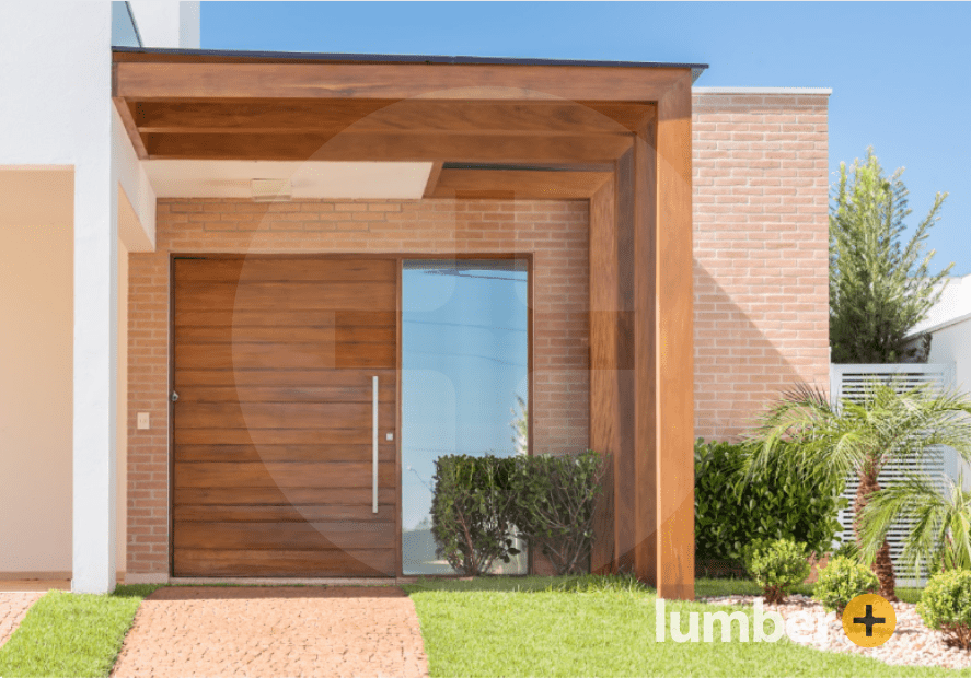 Wood clad door with wooden pergola cover on a brick house. 