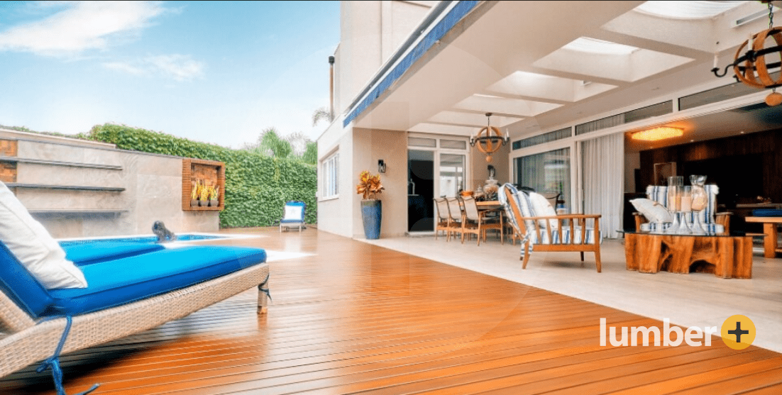 Warm red wood deck on a back porch patio with seating area.