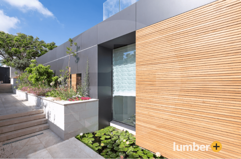 Thermo Ayous wood cladding retaining wall next to a Koi pond.