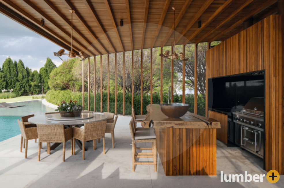 an image of an outdoor kitchen with hardwood ceiling panels, wall supports, and siding