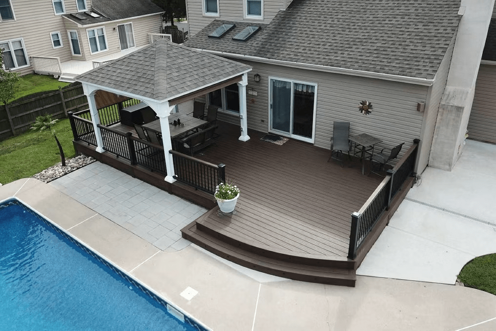 Wide brown Trex deck step leading to the pool area.