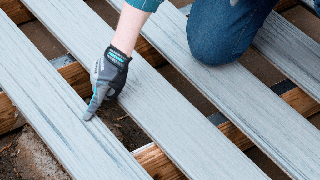 Upclose Image of the install process of a Trex deck board spacing.