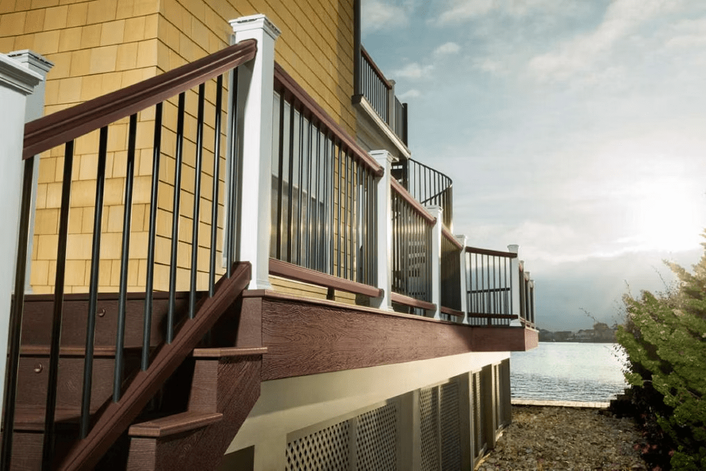 A deck railing design with rich brown railing and aluminum infill.