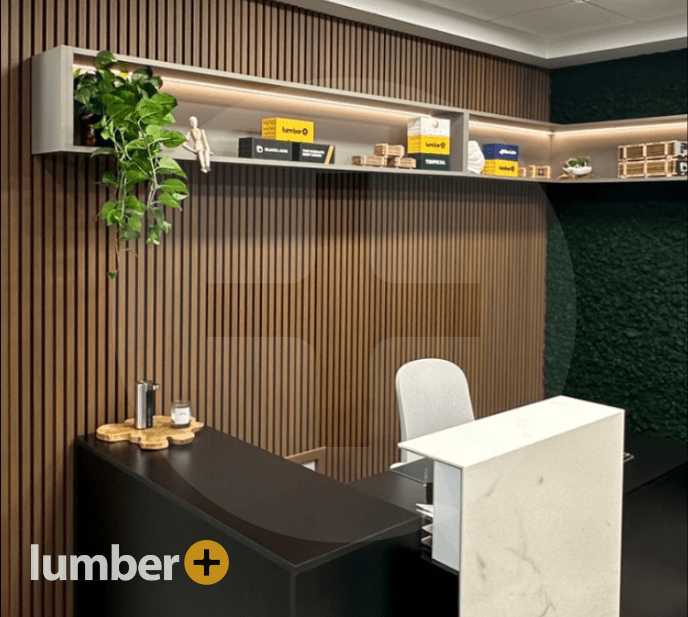 Wood panels line the wall of an office space with a desk.